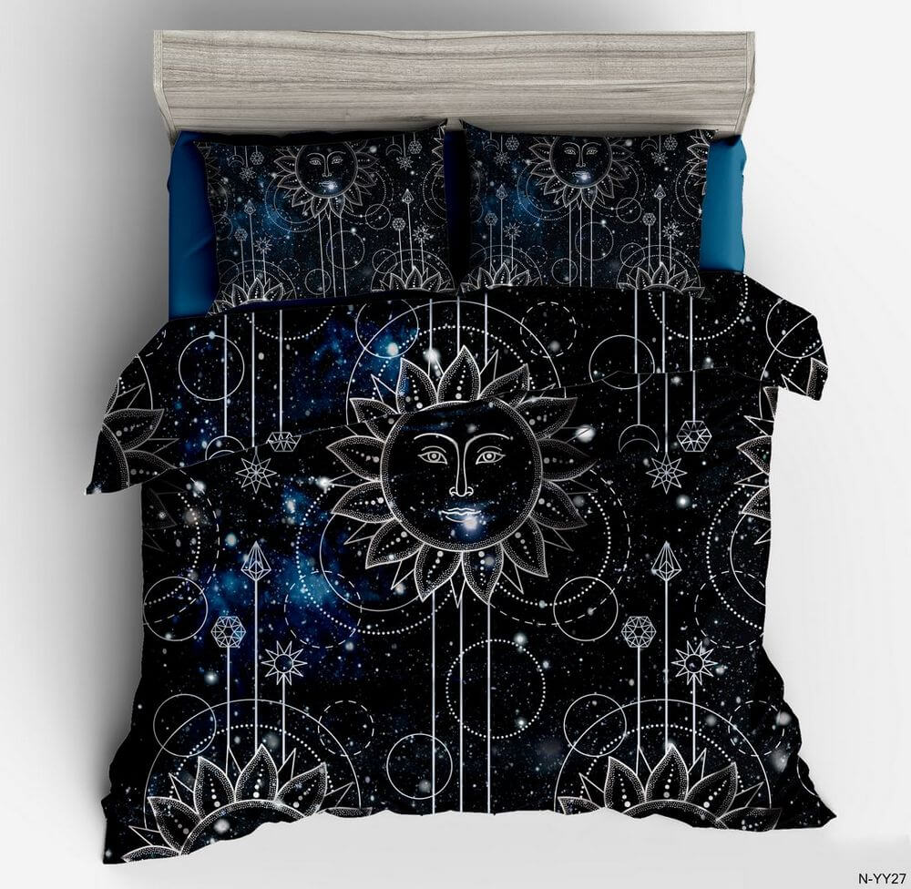 A bedding set featuring a duvet cover and two pillowcases with a celestial sun and moon pattern on a black and blue starry background, styled on a bed with a gray headboard.