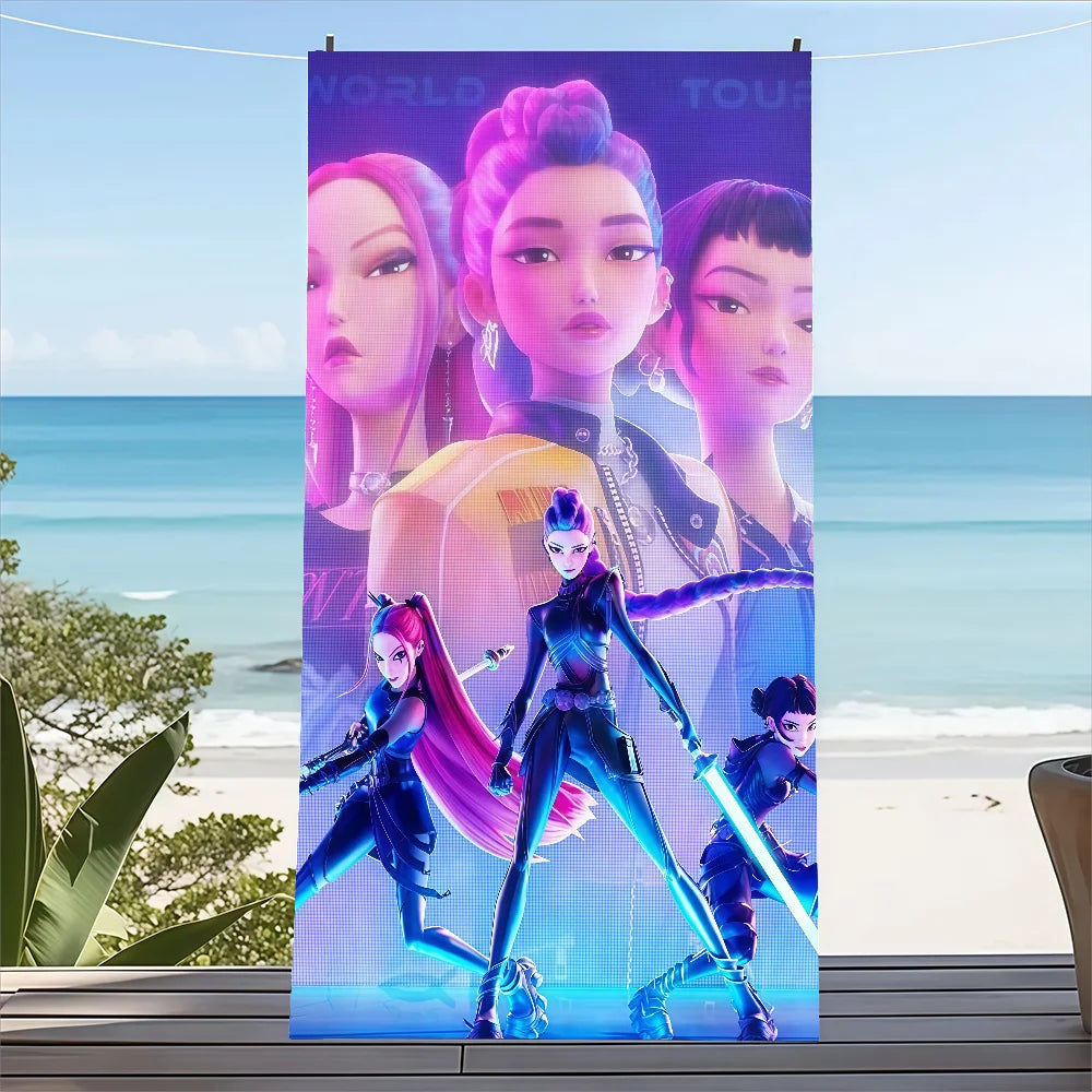 Child holding vibrant K-pop themed Demon Hunter towel at the beach