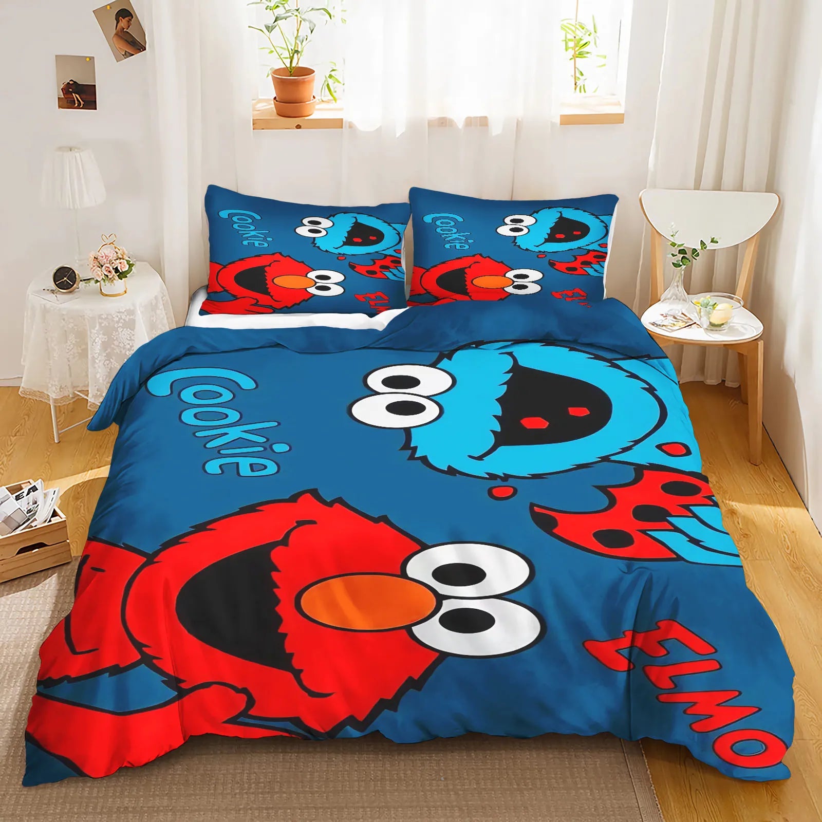 Cookie Monster and Elmo smiling on a bright blue duvet cover with stars and cookies.