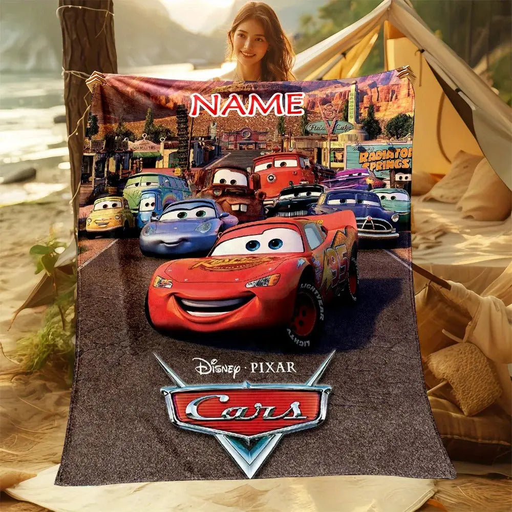 Lightning McQueen custom name blanket spread on a bed, perfect for kids' bedroom decor and cozy comfort