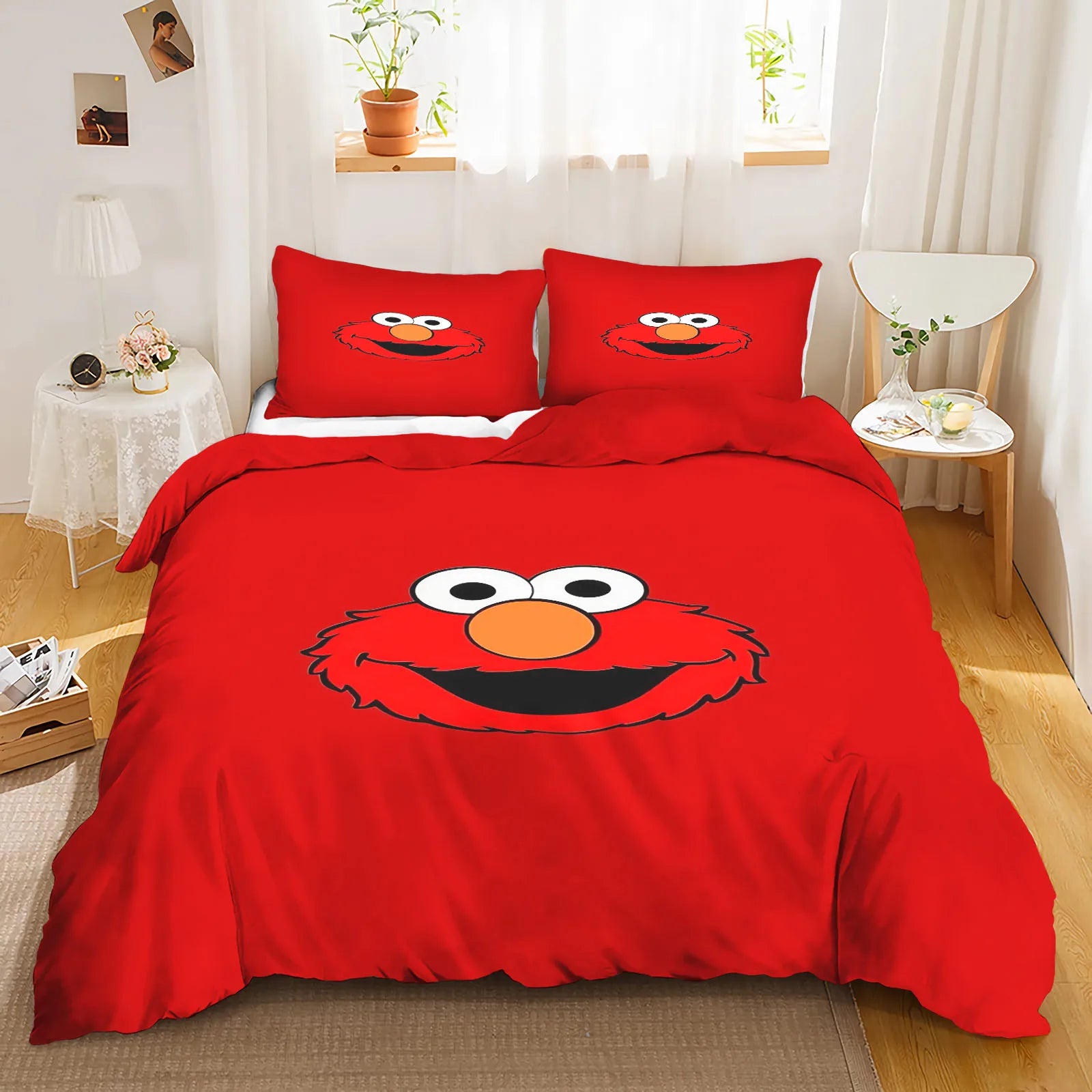 Elmo waving with a big smile, surrounded by colorful stars and letters on the bedding.