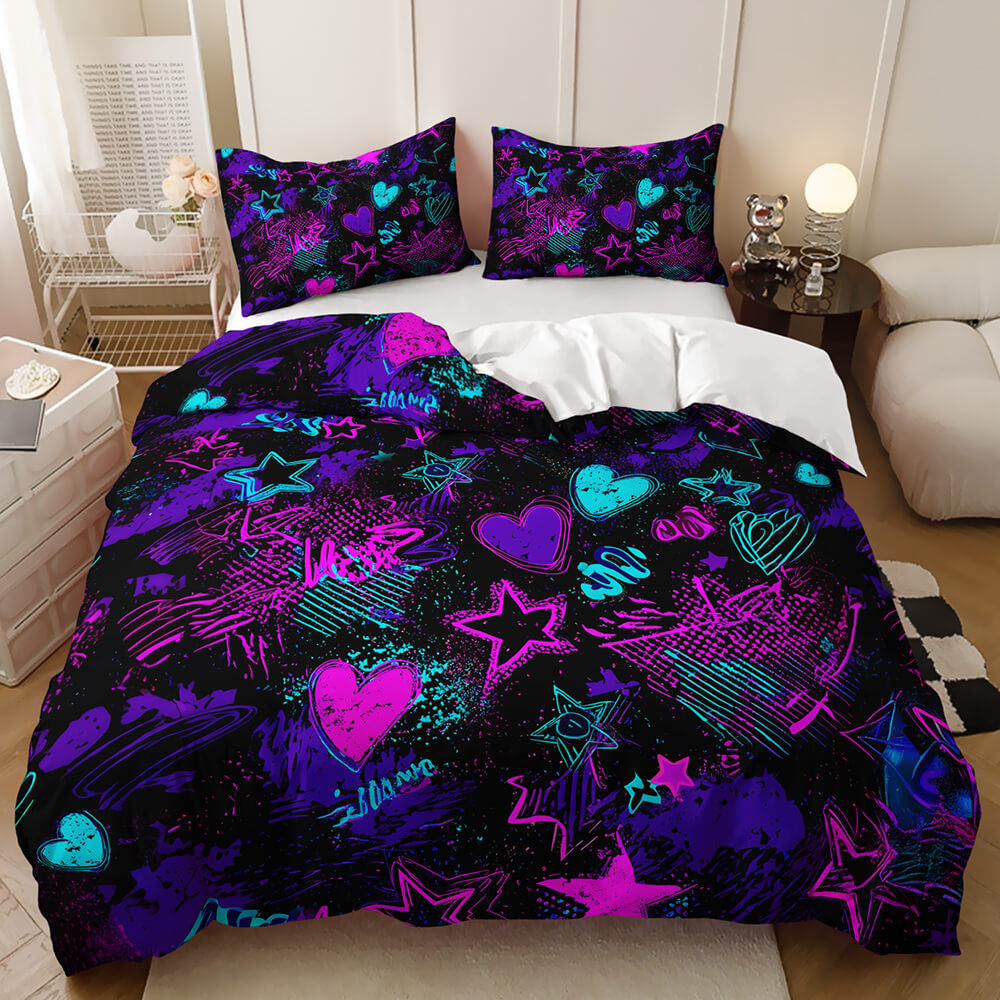 A bed dressed in a bold black bedding set featuring neon-style purple, pink, and turquoise star, heart, and graffiti-inspired patterns, shown in a styled bedroom setting.