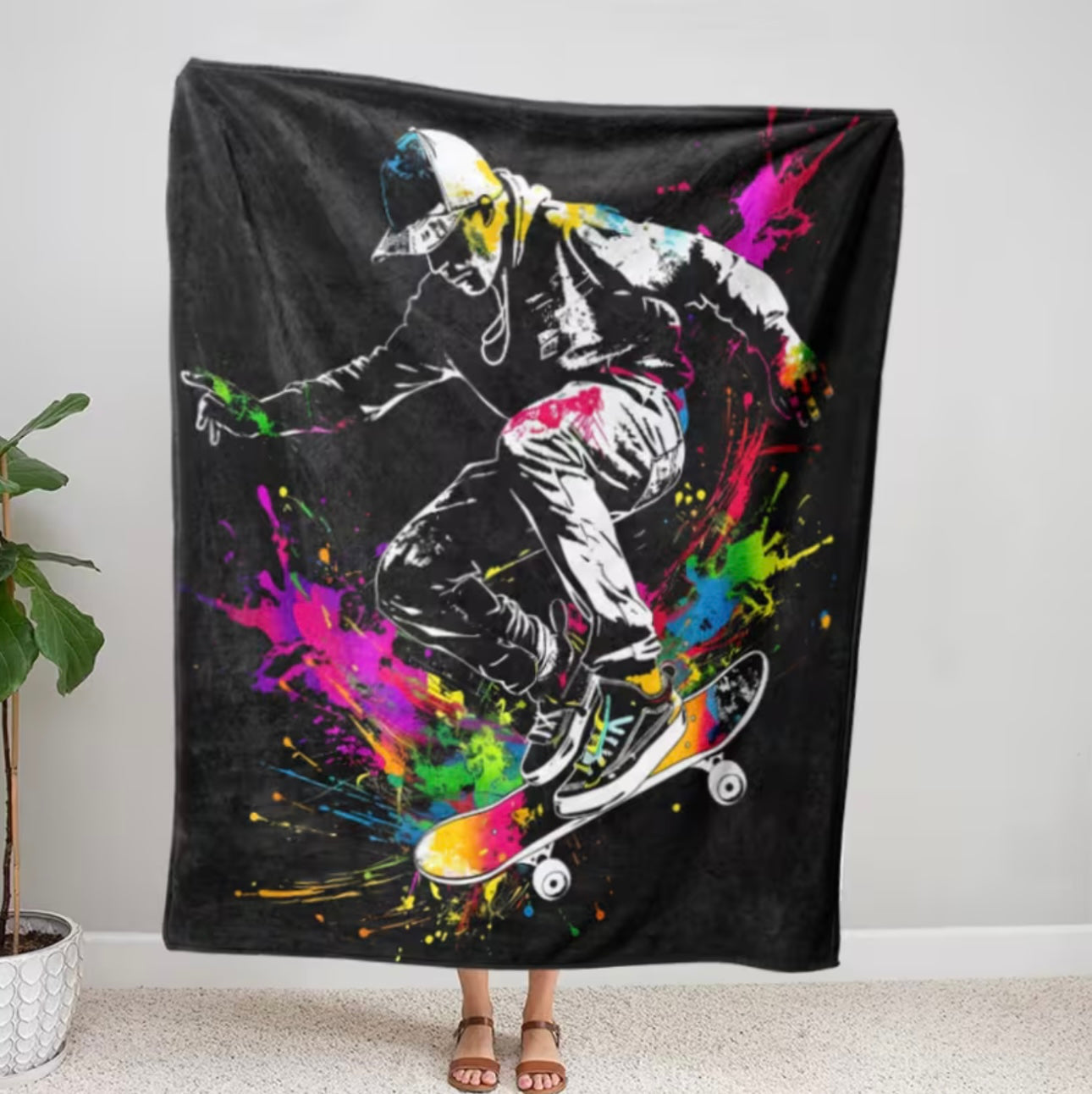 Colorful blanket with a skateboarder design on a black background