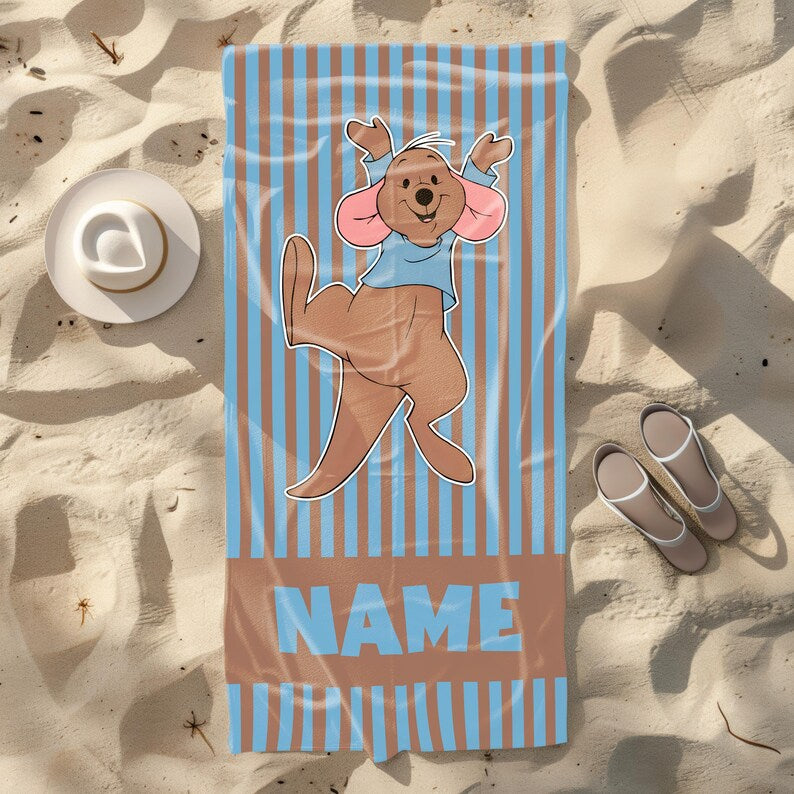 Personalized brown and blue striped beach towel with Roo from Winnie the Pooh jumping joyfully, designed for kids and Disney lovers, name area included.