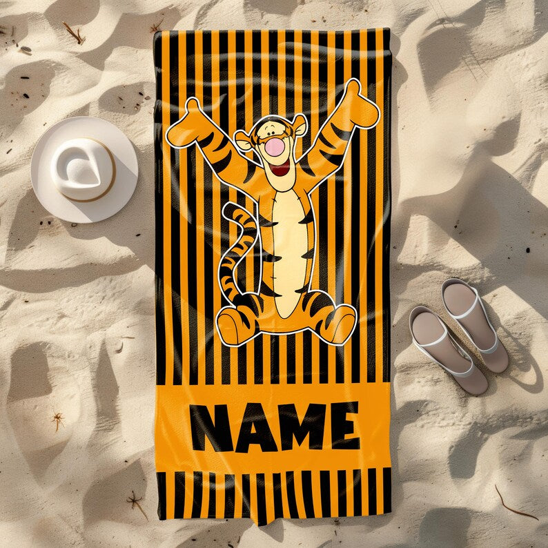 Personalized orange and black striped beach towel featuring Tigger from Winnie the Pooh with arms raised, perfect for kids or Disney fans, customizable with a name.
