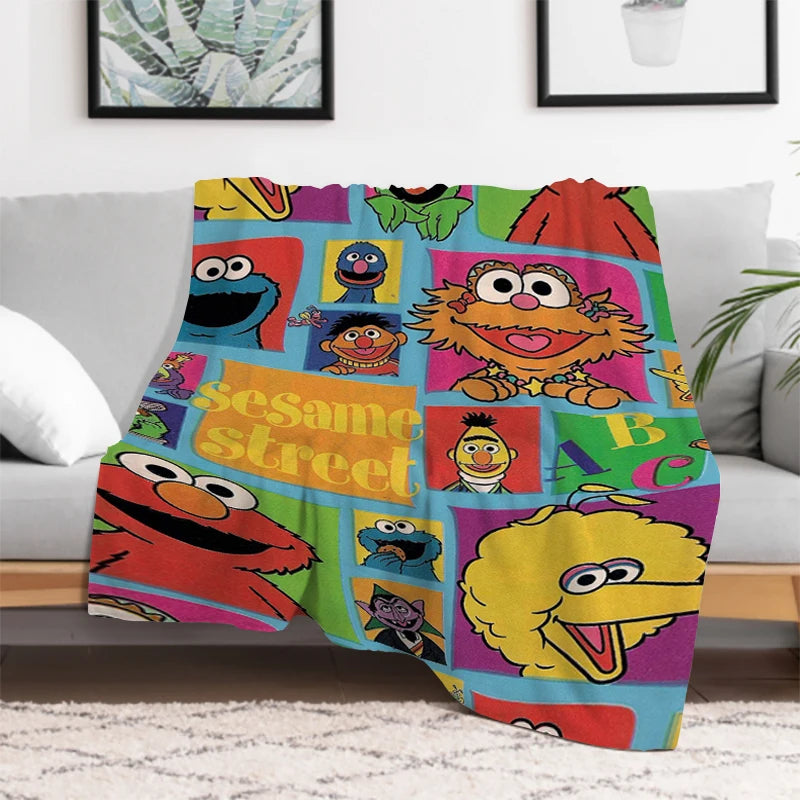Sesame Street blanket featuring Cookie Monster and Elmo on a bed