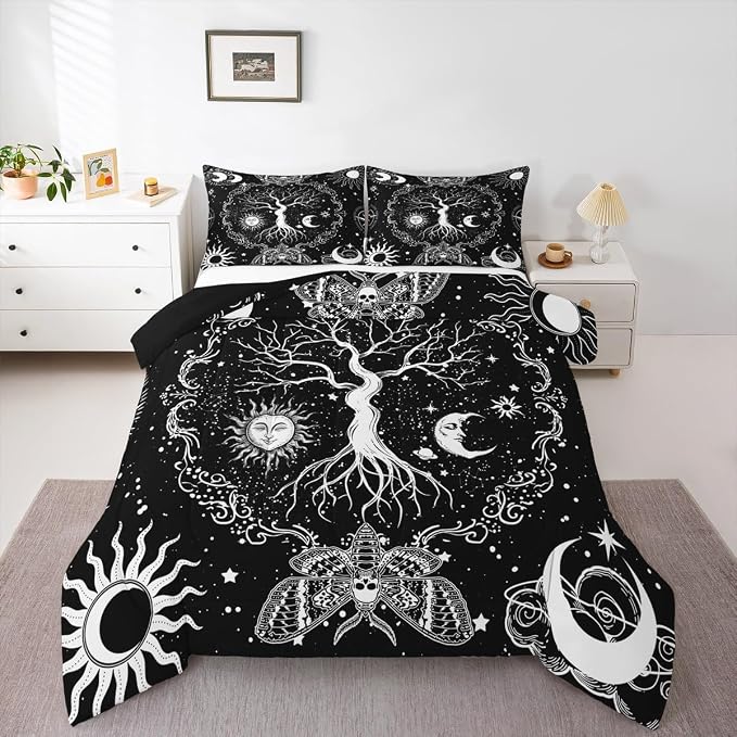 Black and white celestial-themed bedding set on a bed in a bedroom.