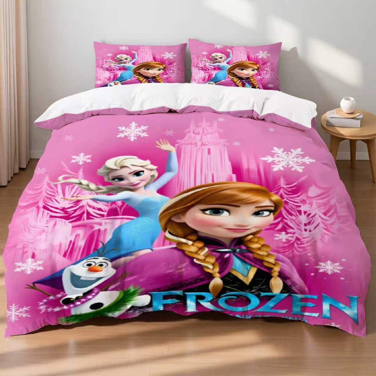 Pink 'Frozen' themed bedding set with characters on a bed in a room.
