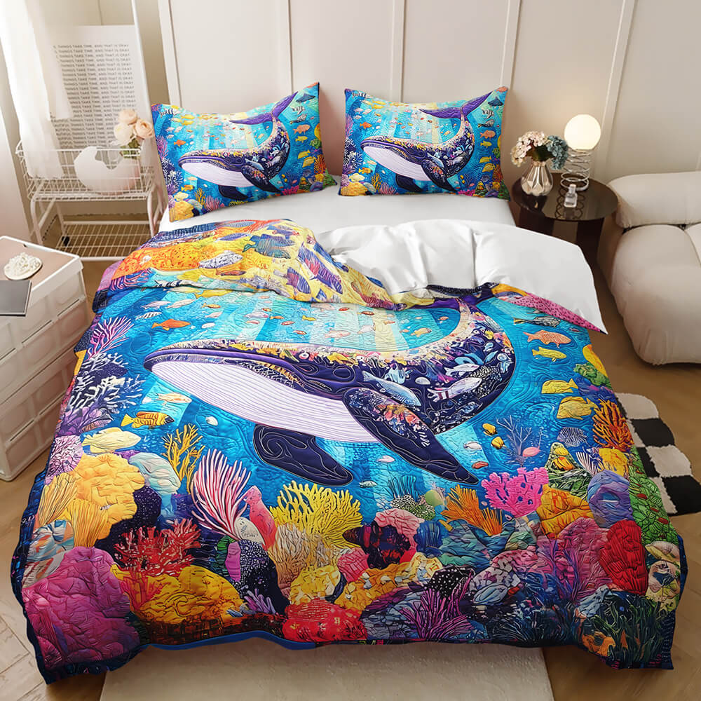 A colorful ocean-themed bedding set featuring a vibrant whale and coral reef print, shown on a made bed in a styled bedroom setting.
