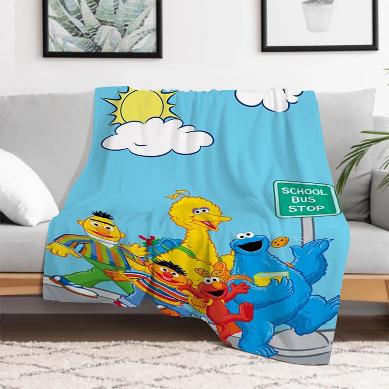 Child wrapped in Sesame Street Cookie Monster and Elmo blanket