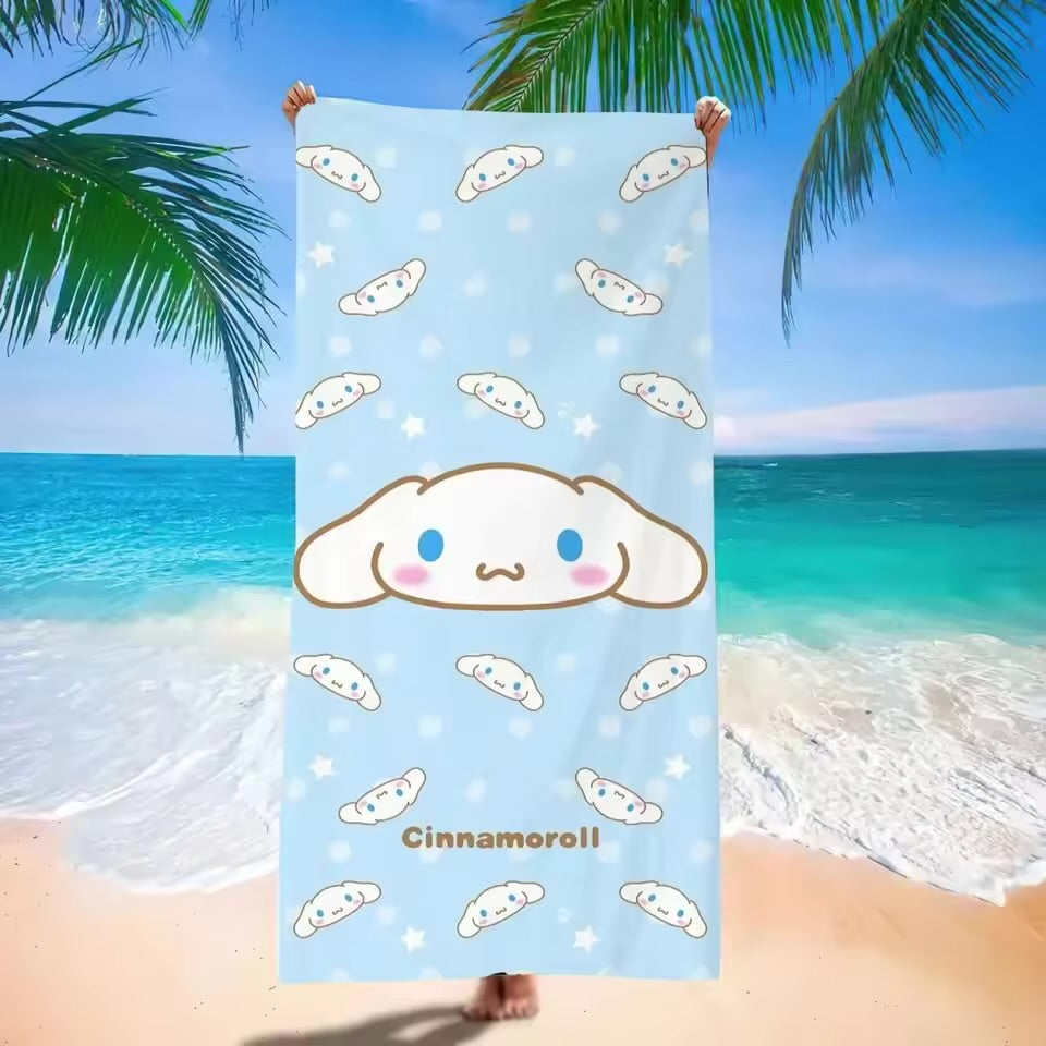 Cinnamoroll-themed towel held up against a beach background