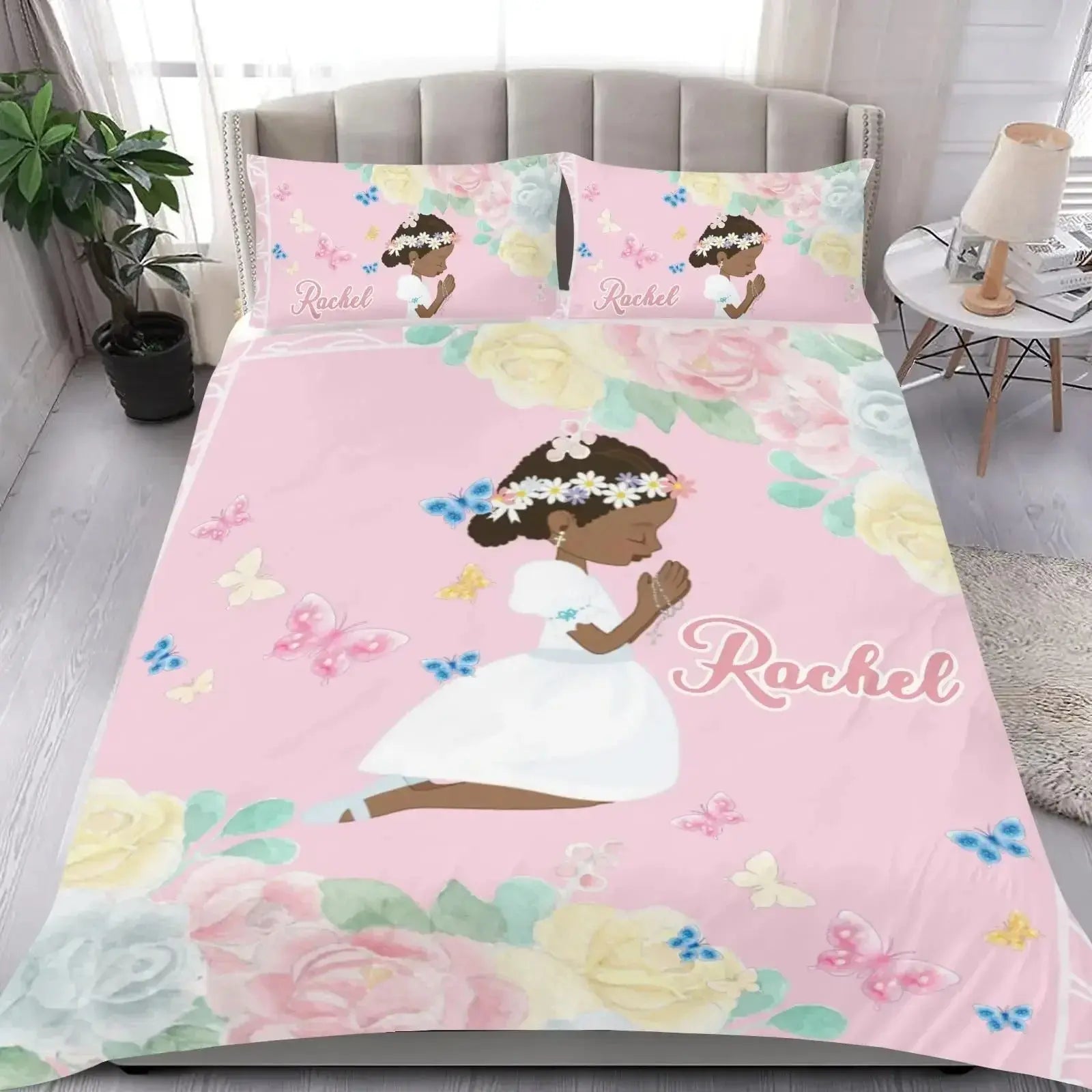Bedding set with 'Name' design on a pink floral background in a soft, elegant room setting