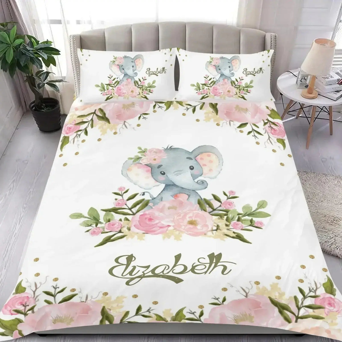 Bedding set featuring elephant and floral design with name printed, displayed on a bed in a bedroom setting