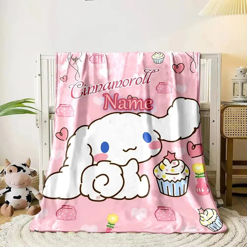 Kids’ cartoon blanket featuring Cinnamoroll with personalized name print, shown folded neatly