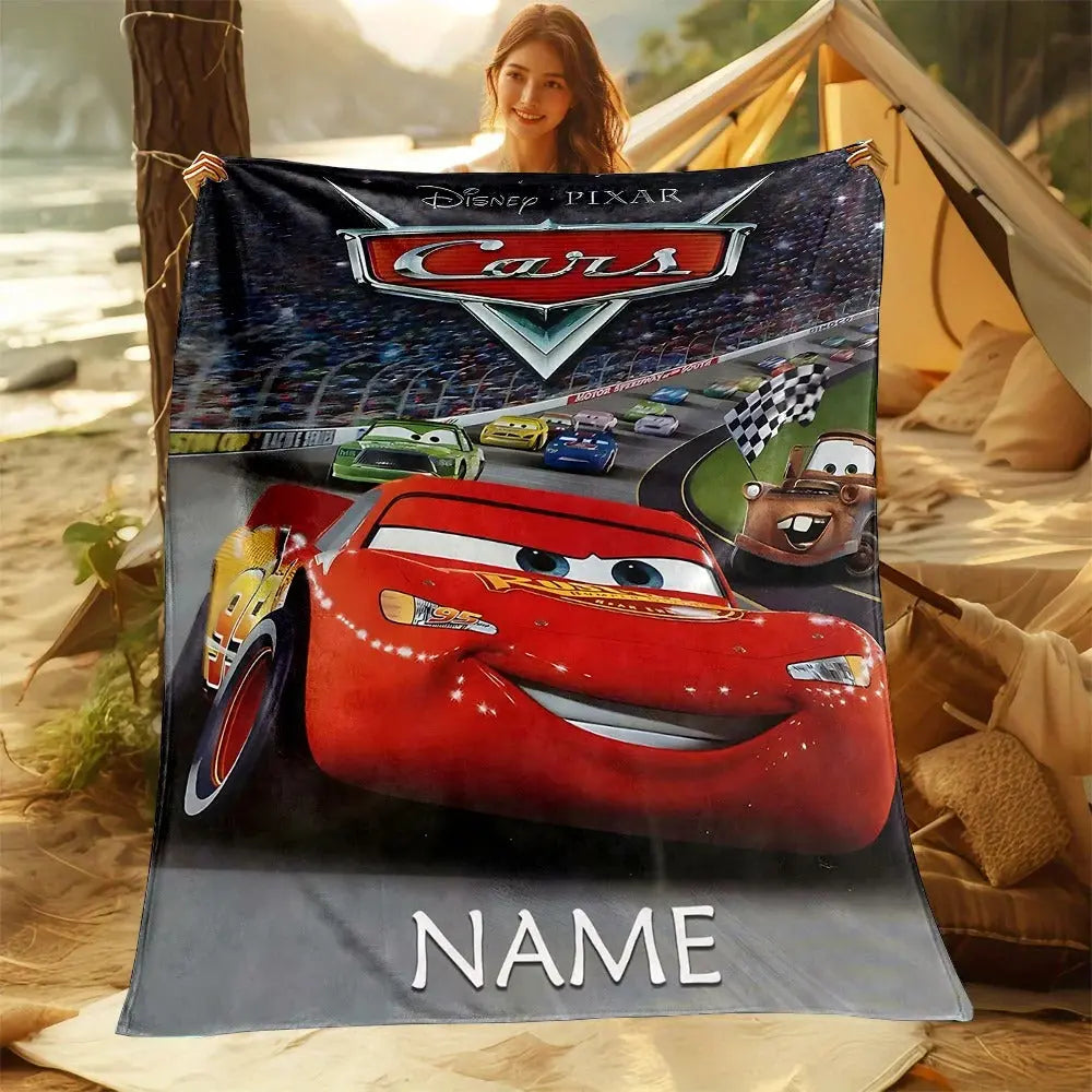 Disney Cars-themed Lightning McQueen blanket with customized name, placed on a sofa for kids’ movie nights