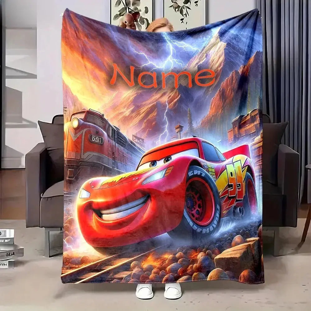Soft plush Lightning McQueen blanket with customized name, displayed folded for travel and gift packaging
