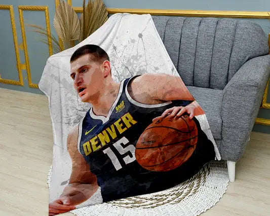 Nikola Jokić splash effect flannel blanket featuring bold NBA player graphics, ultra-soft warm fabric, and vibrant Denver Nuggets-themed design perfect for basketball fans’ bedding or couch throw