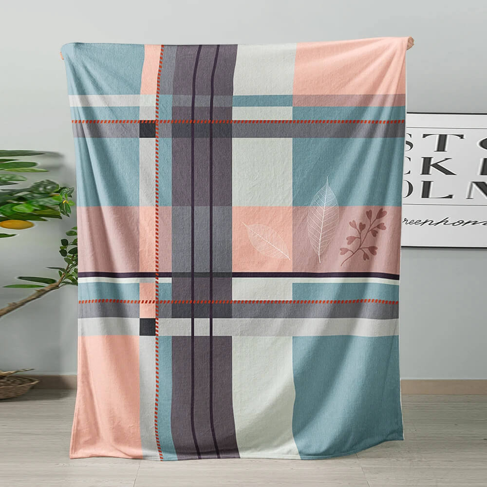 Geometric flannel blanket draped over a bed