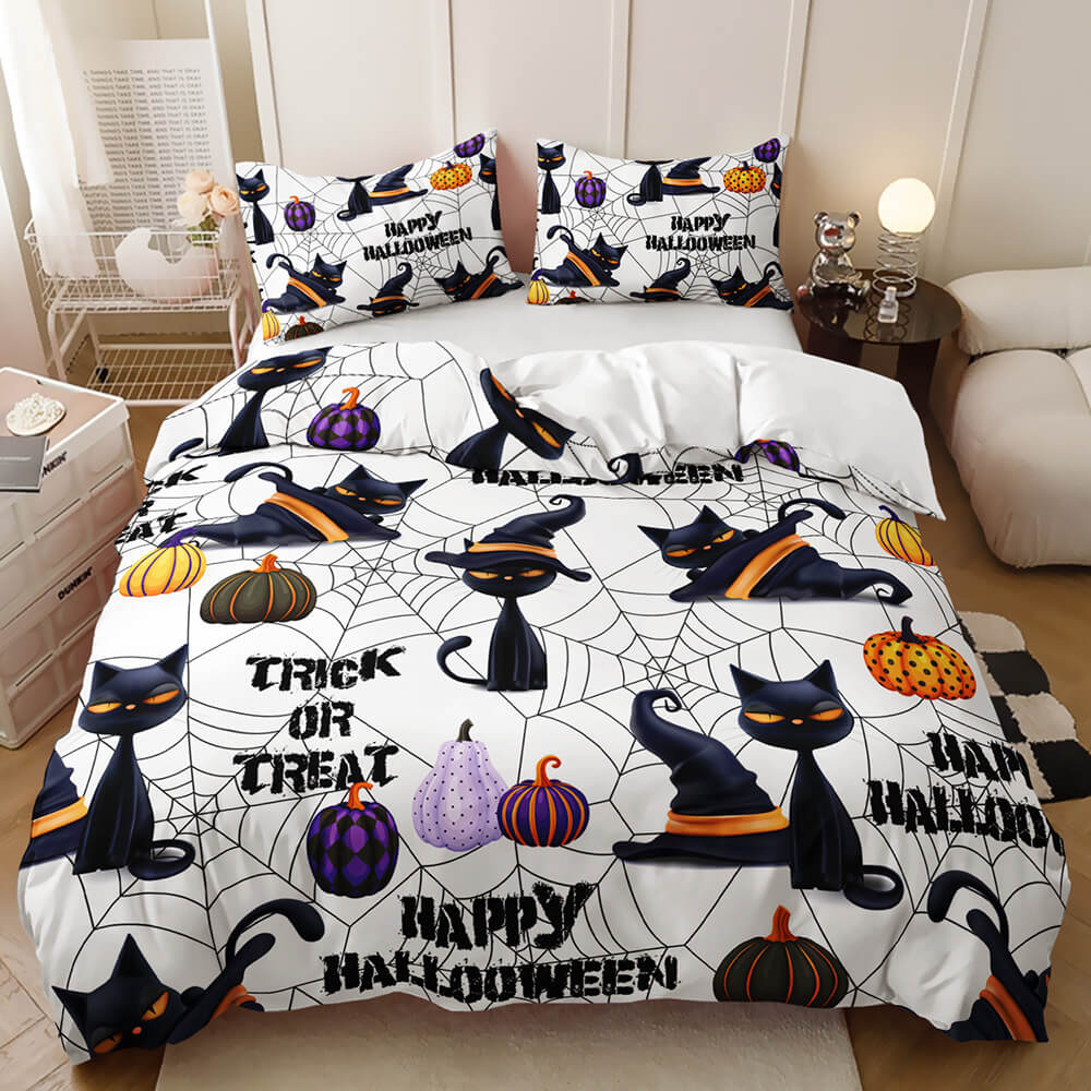 A Halloween-themed bedding set featuring a duvet cover and two pillowcases with a black cat, spiderweb, pumpkin, and spider graphic pattern on a white background, styled on a bed in a bedroom setting.