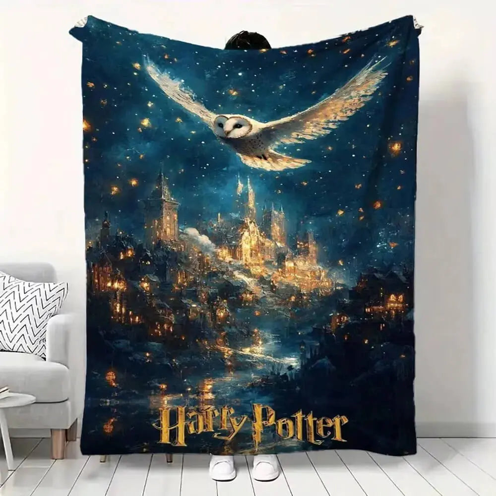Harry Potter-themed blanket with an owl and magical city design