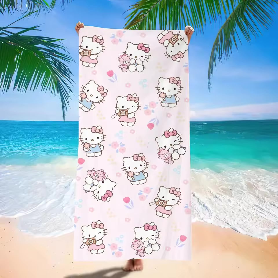 Hello Kitty beach towel with ocean and palm tree in the background