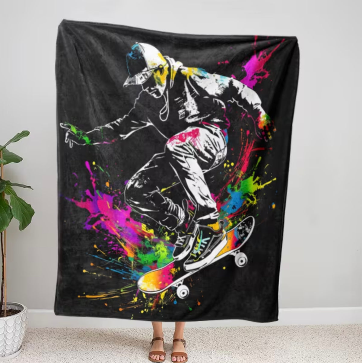 Colorful blanket with a skateboarder design on a black background