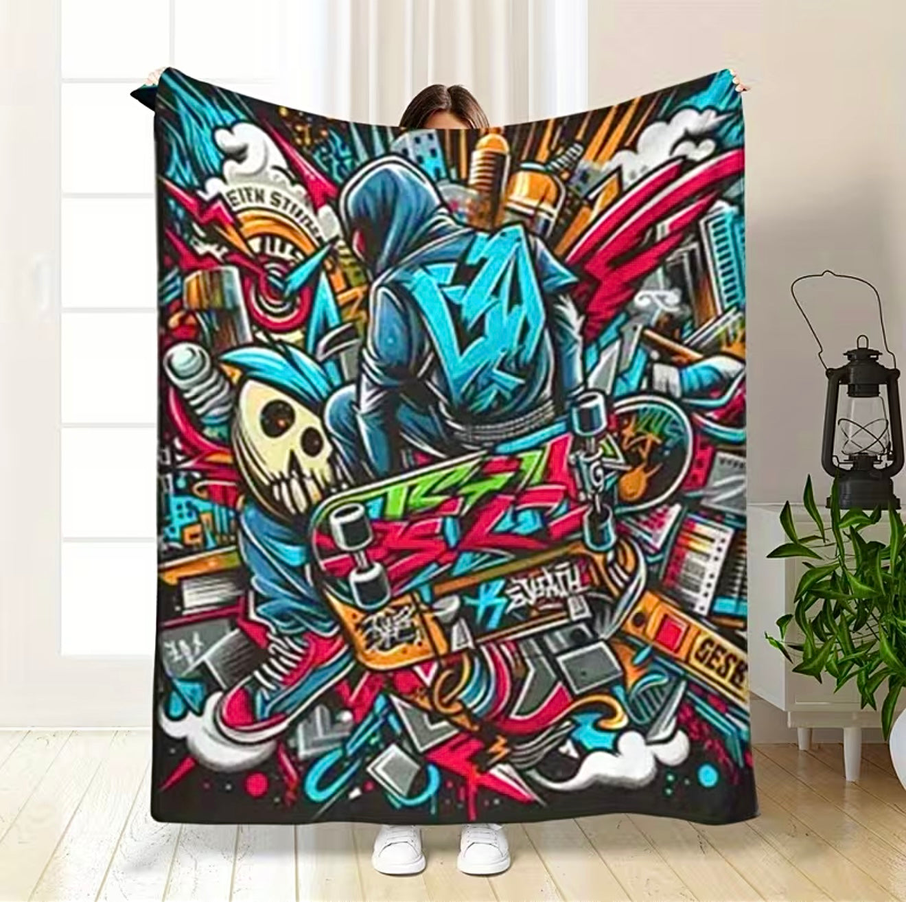 Person holding a colorful blanket with graphic design in a room.