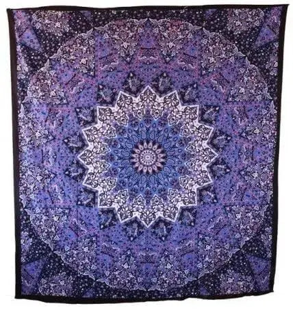 Indian mandala picnic blanket laid out on sandy beach with boho accessories