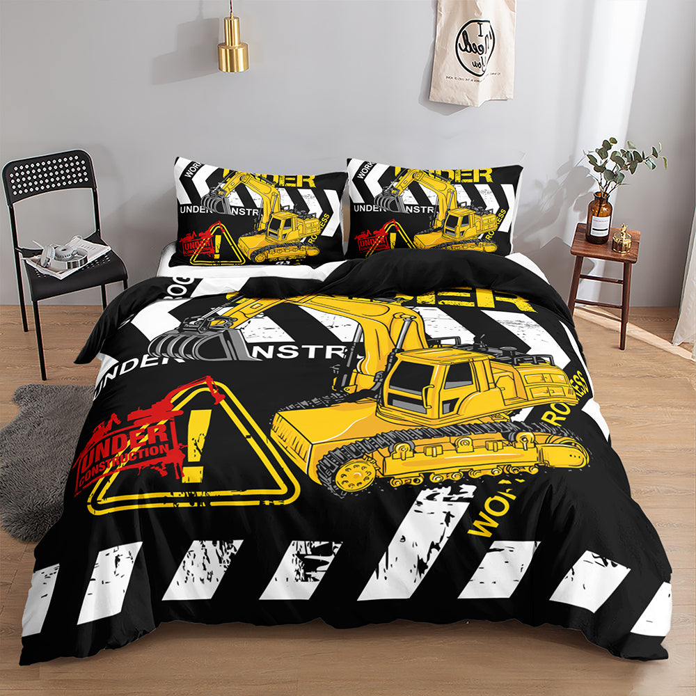 A bedding set styled on a bed in a bedroom, featuring a black duvet cover and matching pillowcases with a bold yellow construction excavator graphic, white hazard stripes, and warning sign illustrations.