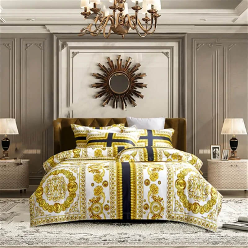 Luxurious bedroom with gold and white patterned bedding, chandelier, and decorative mirror.