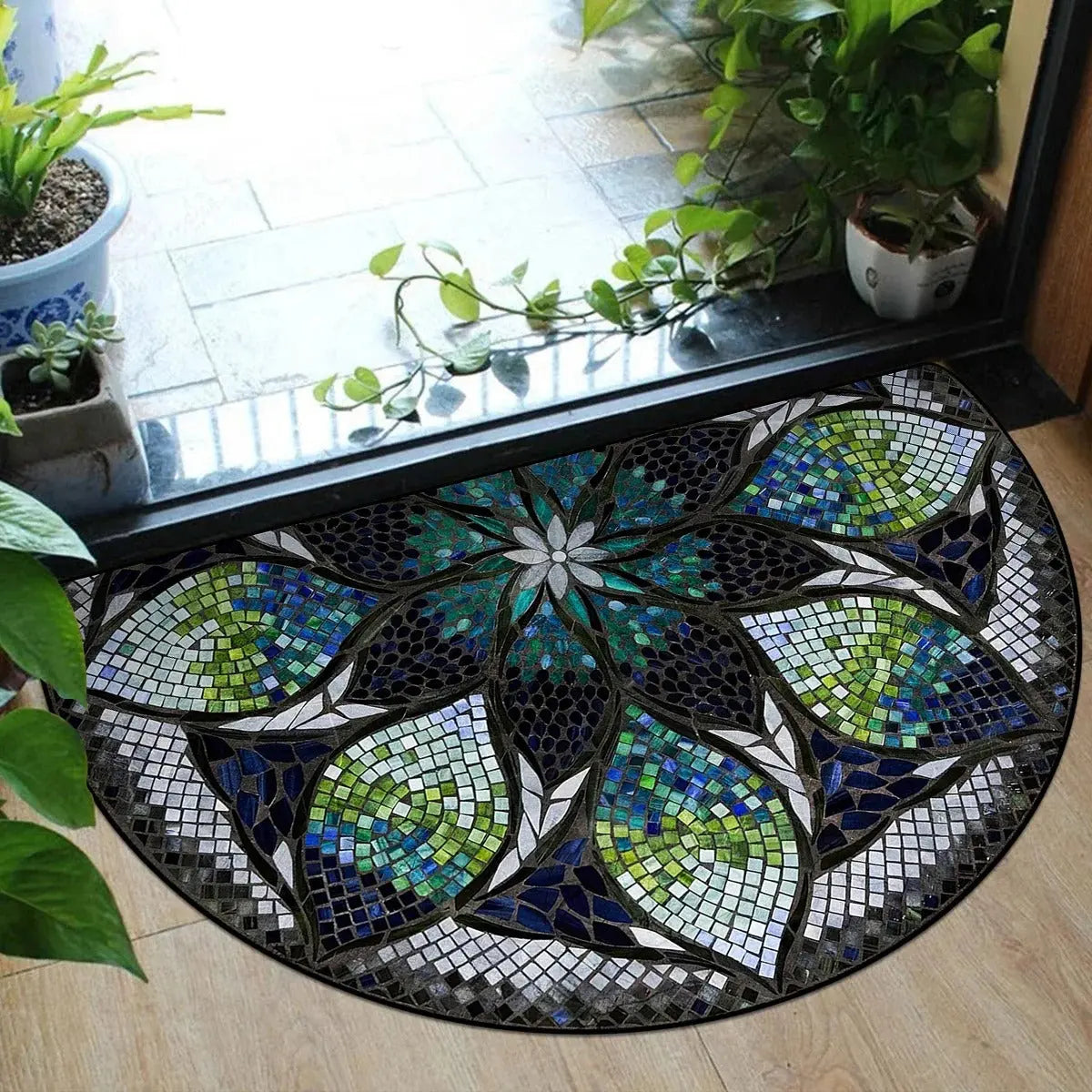 ound rug with mosaic mandala floral pattern in green, blue, white, and black tones placed on wooden floor