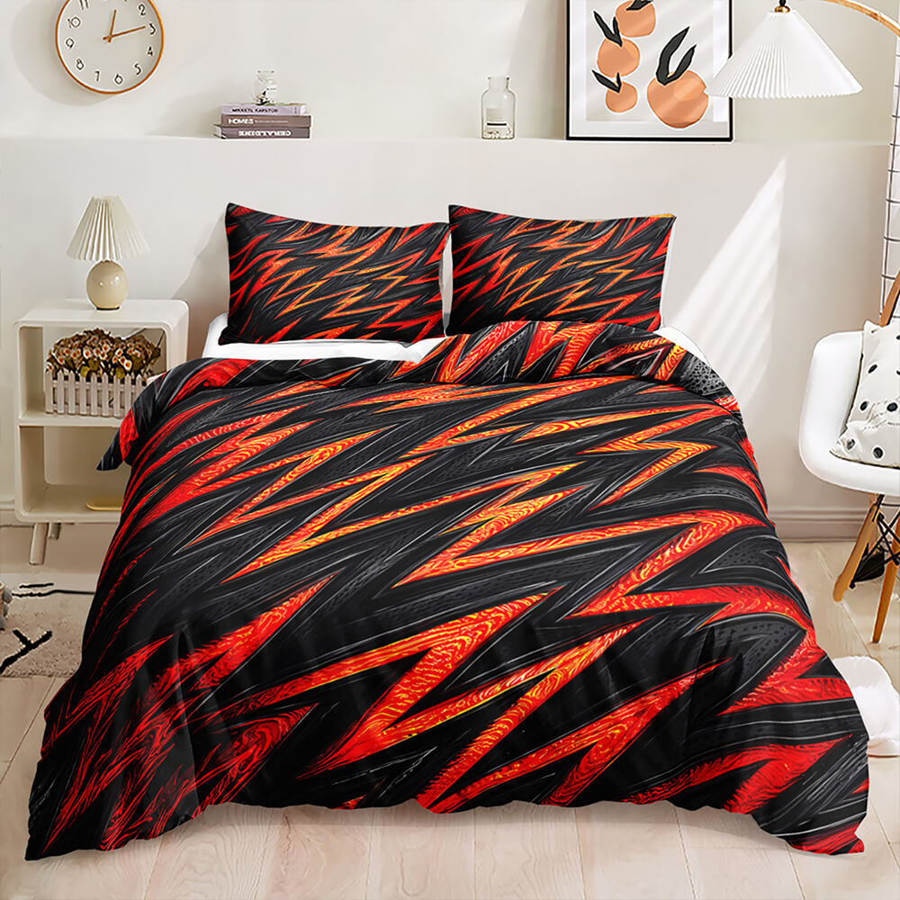 A bedding set with a bold black, red, and orange abstract zigzag pattern, styled on a bed in a modern, bright bedroom.
