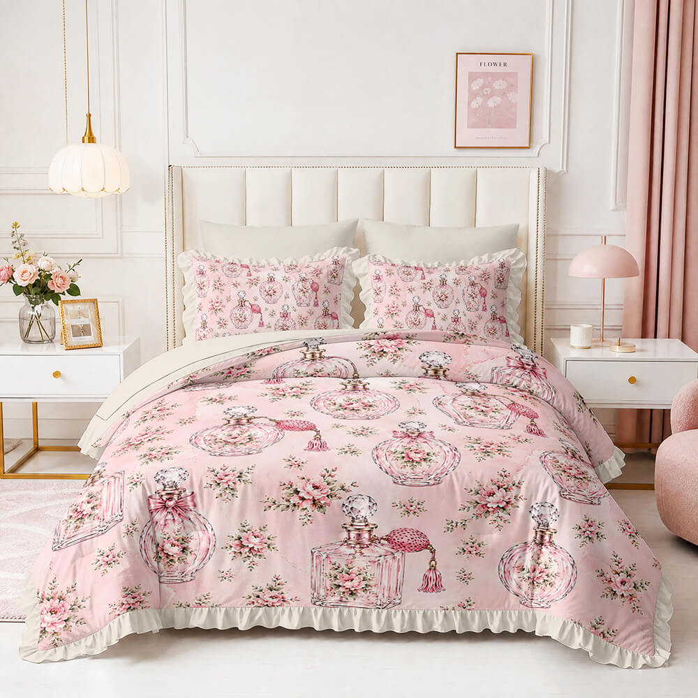 A pink bedding set with a floral and perfume bottle pattern, styled on a bed in a bright, modern bedroom with white walls, bedside tables, and pink accents.