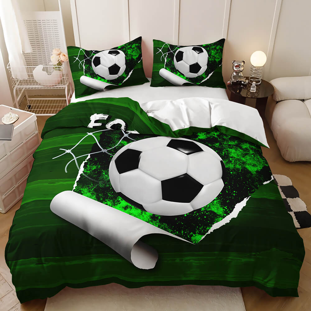 A bed dressed in a soccer-themed bedding set featuring a large 3D-effect soccer ball and matching pillowcases on a dark green background, shown in a bedroom setting.