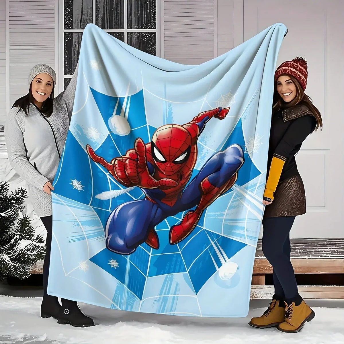 Spider-Man blanket laid on a bed with matching superhero-themed pillow