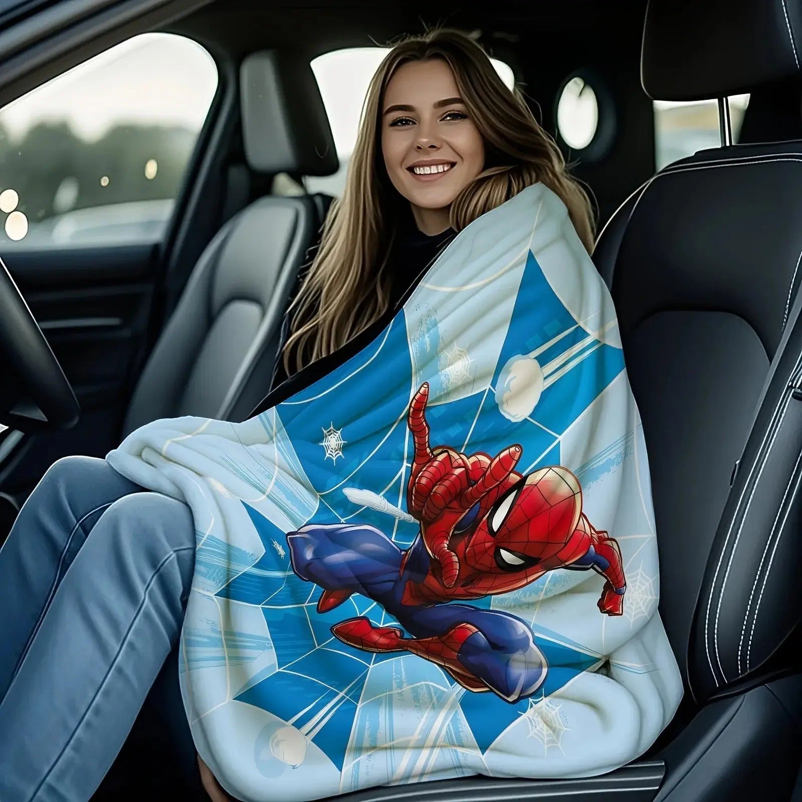 Spider-Man blanket laid on a bed with matching superhero-themed pillow