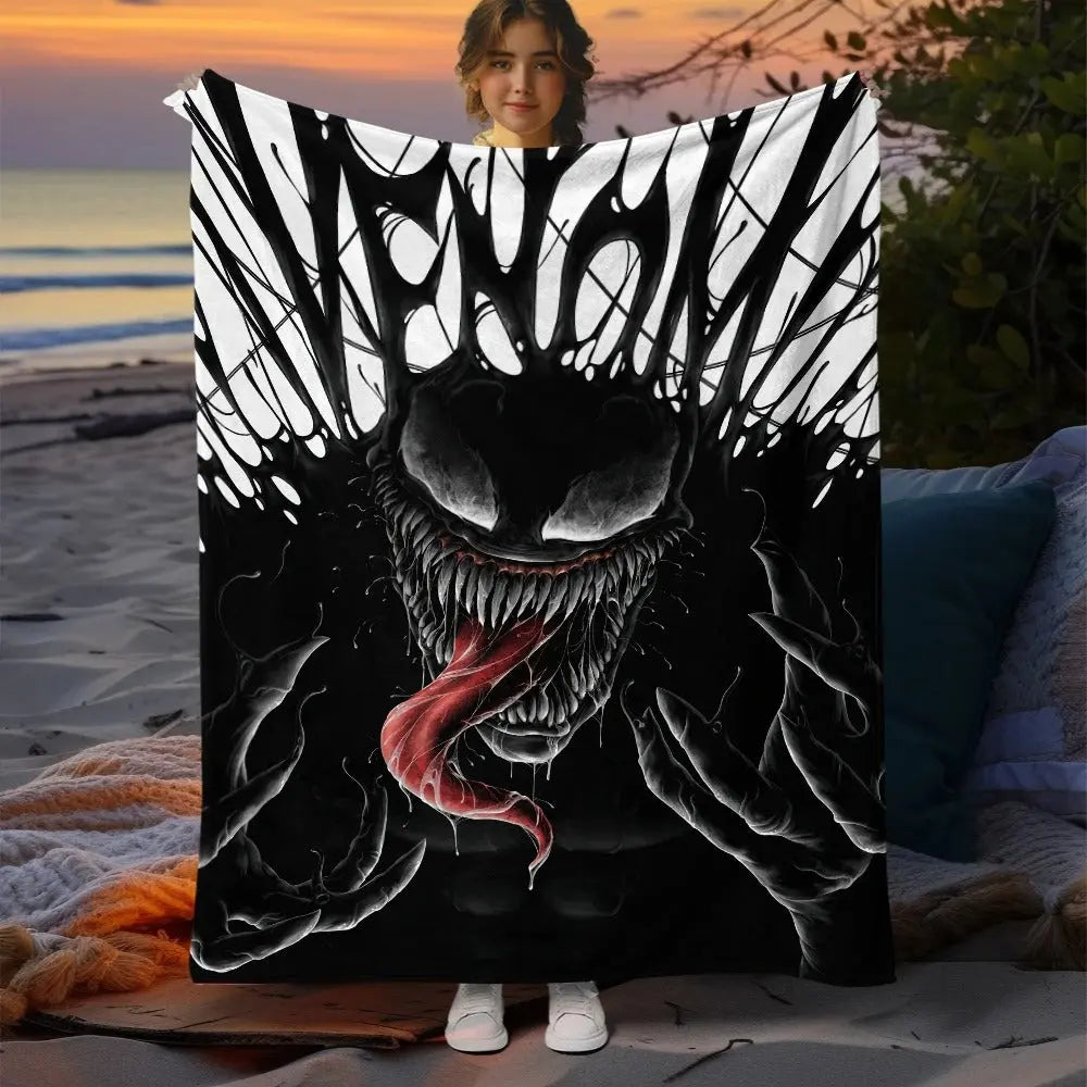 Marvel Venom flannel throw blanket draped on couch with bold print