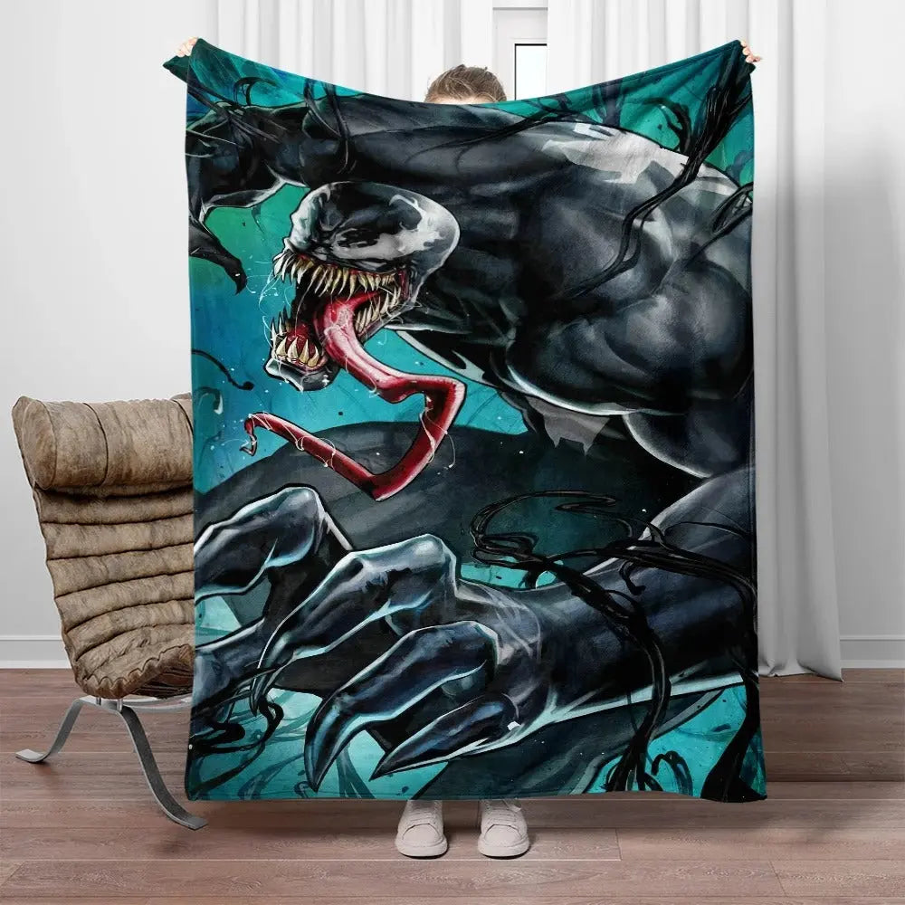 Marvel Venom travel blanket folded on airplane seat with pillow