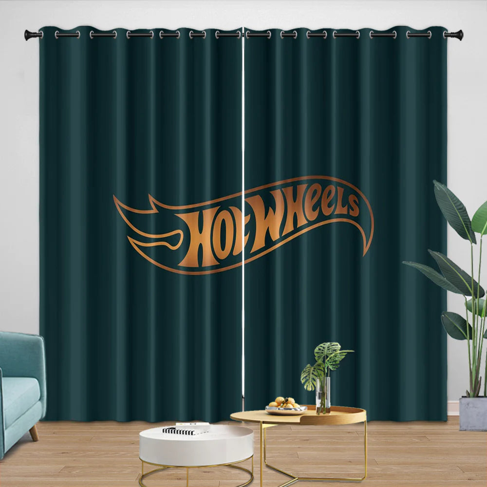 Dark green curtain with Hot Wheels logo in a room with a light blue sofa and small table.