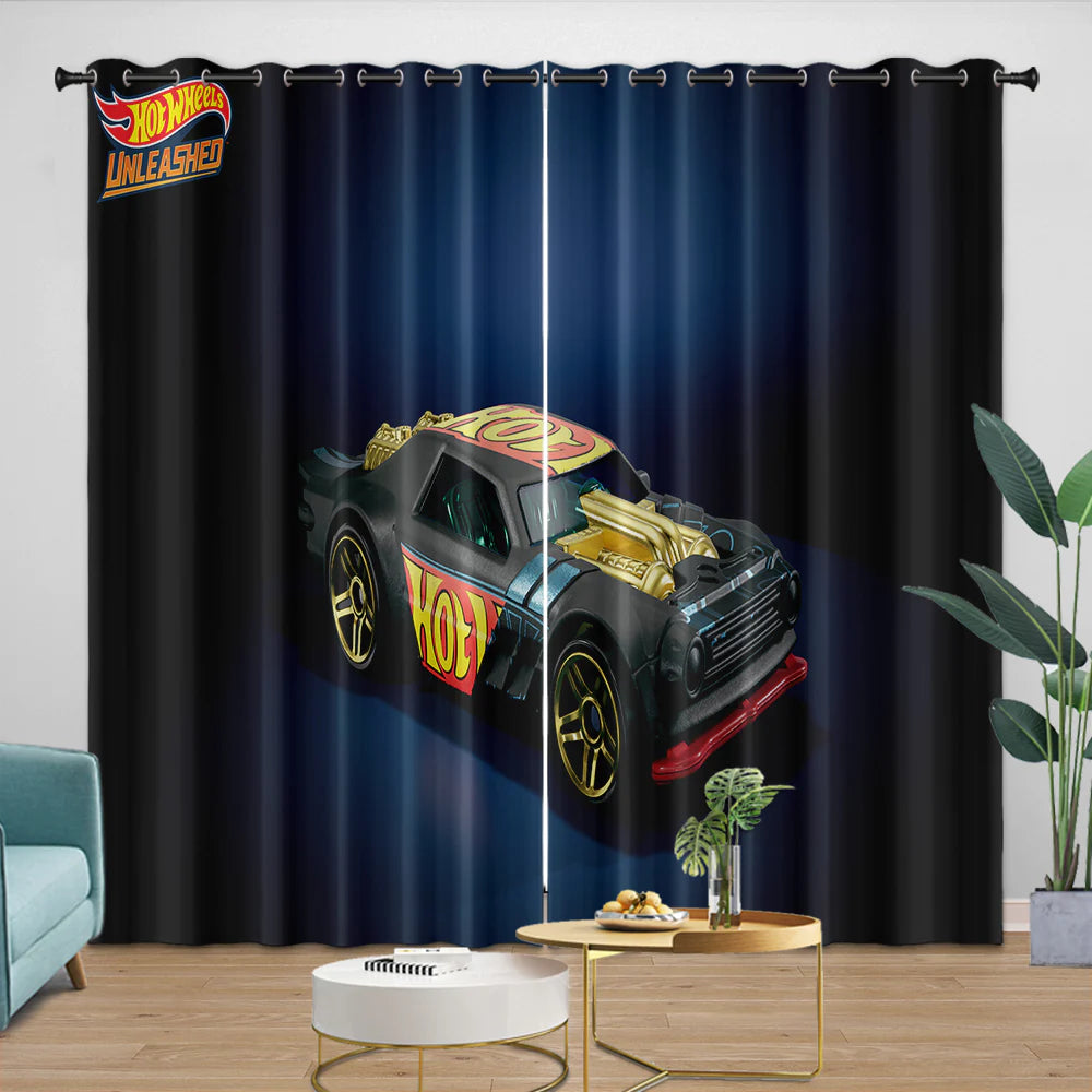 Black curtain with Hot Wheels design featuring a toy car, placed in a room with a couch and table.