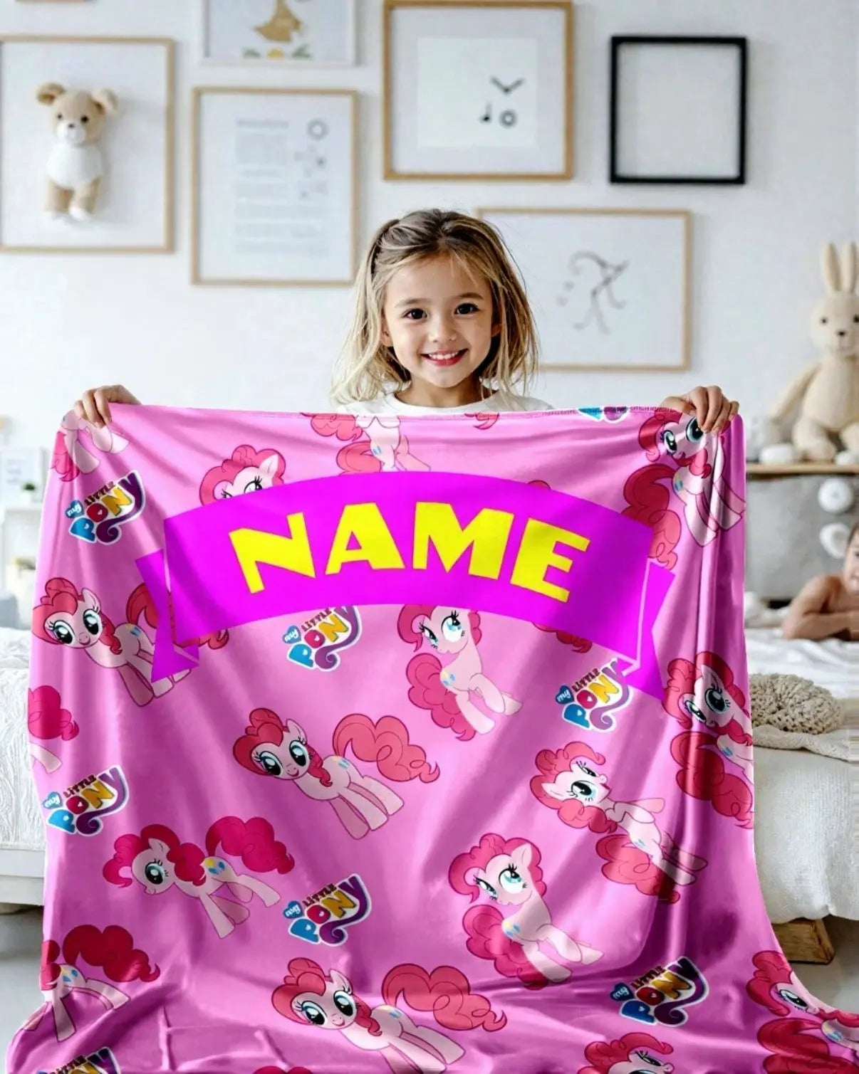 Child holding personalized unicorn kids blanket with custom name, soft magical bedding for girls bedroom decor