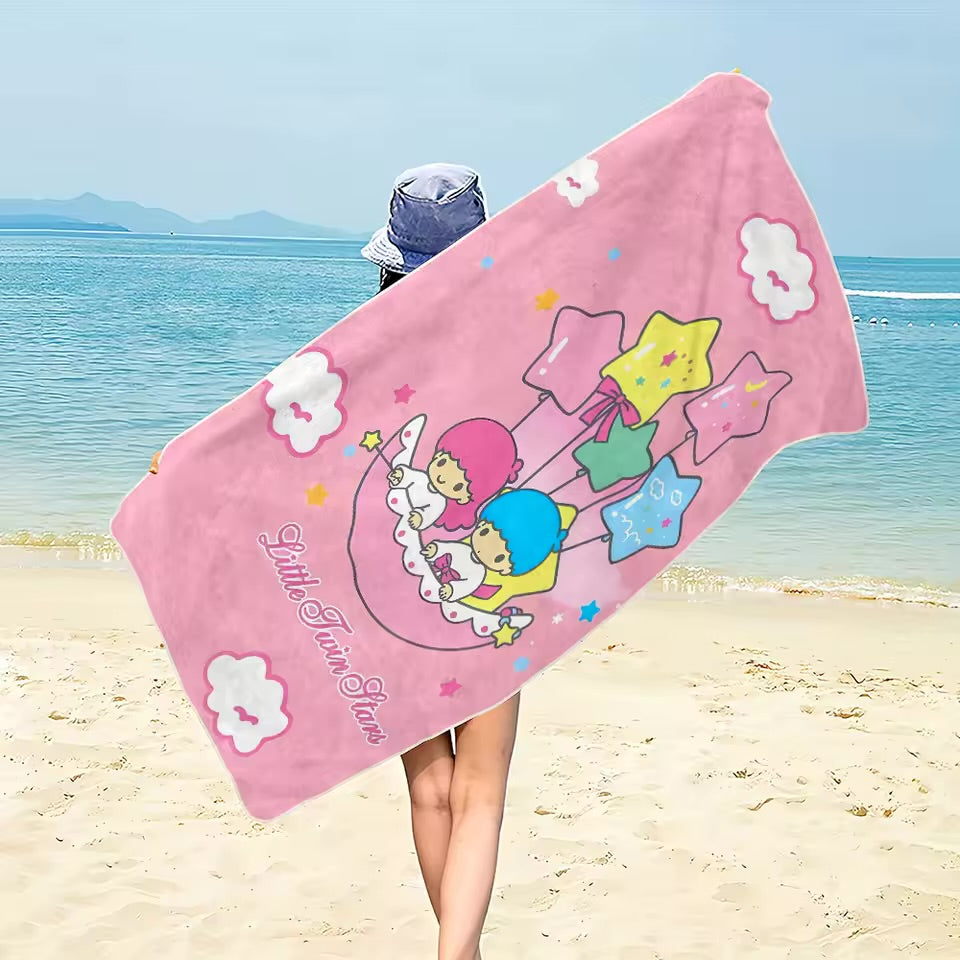 pink 'Little Twin Stars' towel on a beach